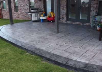 A patio with a grill and a toy car.