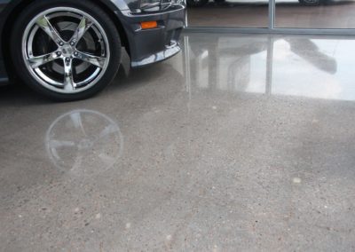 A car parked in the garage with its wheels on.