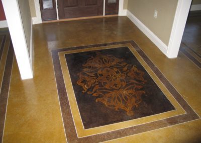 A brown and tan rug in front of a door.