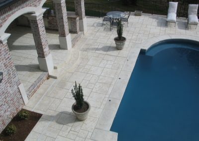 A pool with a table and chairs next to it