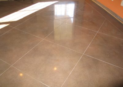 A tile floor with a shiny finish in the center.