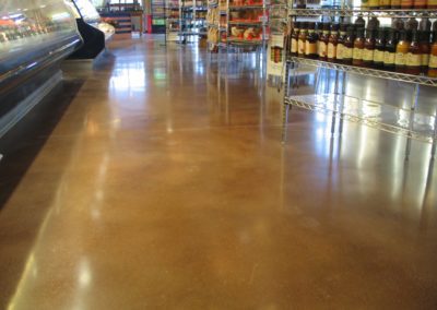 A store floor with several bottles of wine on the ground.