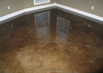 A brown floor with a window in the corner