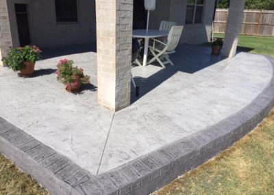 A patio with a table and chairs on it