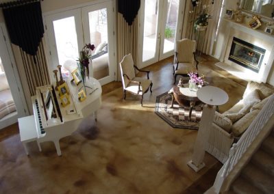 A living room with two chairs and a piano