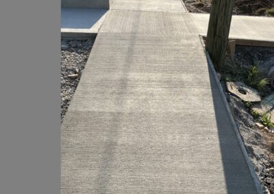 A sidewalk is being built in front of a house.