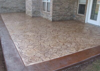 A patio with a stamped concrete floor.