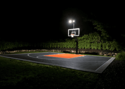 A basketball court lit up at night.